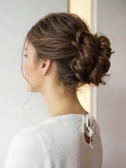 Professional styling using wedding hairstyles for guests.